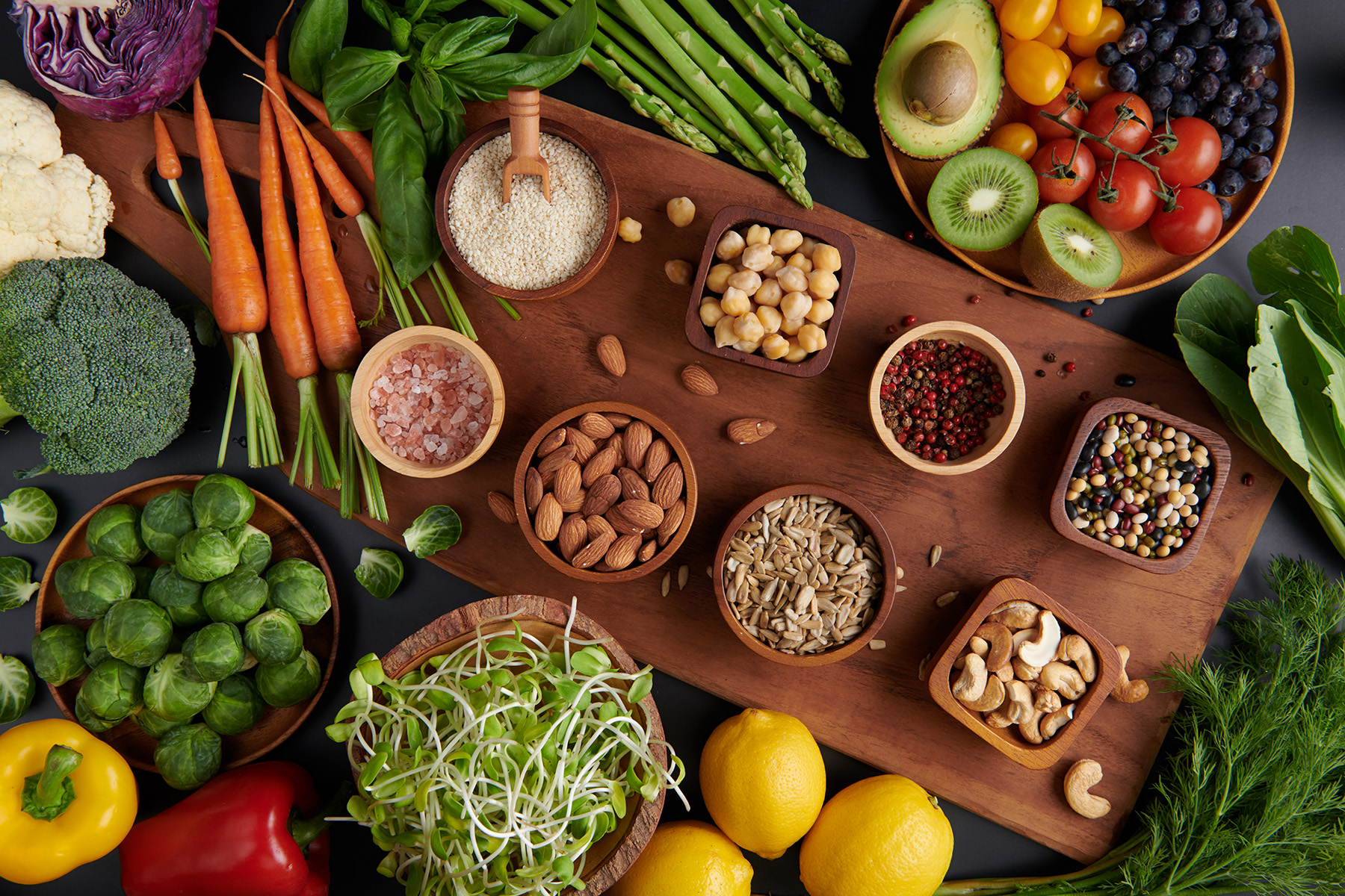 Different vegetables, seeds and fruits on table. Healthy diet.
vegetarian, vegan food cooking ingredients. Flat-lay of vegetables, fruit, beans, cereals, kitchen utencil, dried flowers, top view.